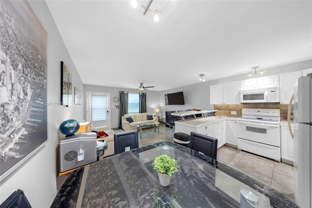 dining space with light tile patterned floors and a ceiling fan