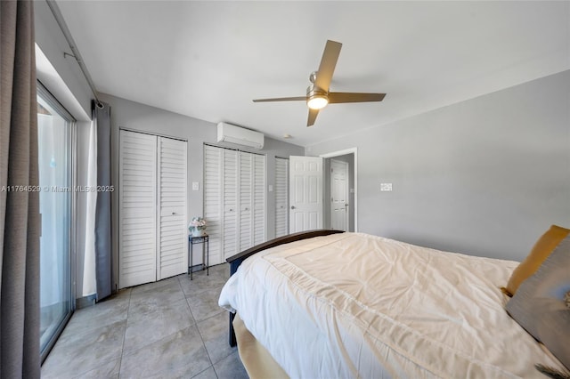 bedroom featuring light tile patterned floors, multiple closets, a ceiling fan, and a wall mounted AC