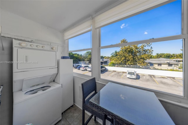 interior space with stacked washer and clothes dryer