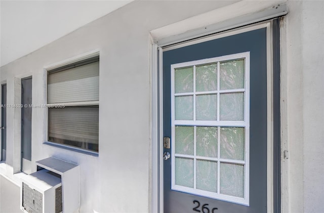 entrance to property with stucco siding