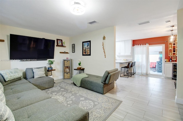 living area featuring visible vents and baseboards