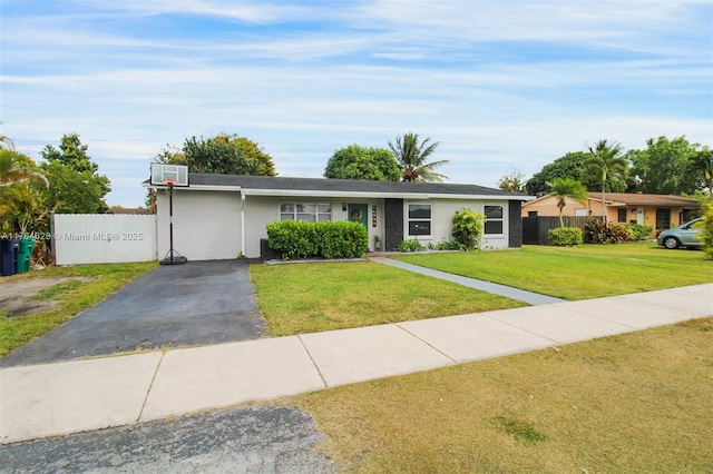 single story home featuring stucco siding, a front lawn, and fence