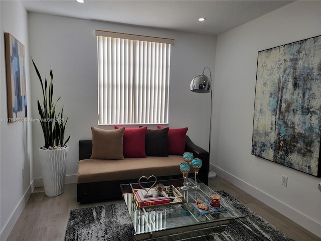 living area with recessed lighting, wood finished floors, and baseboards