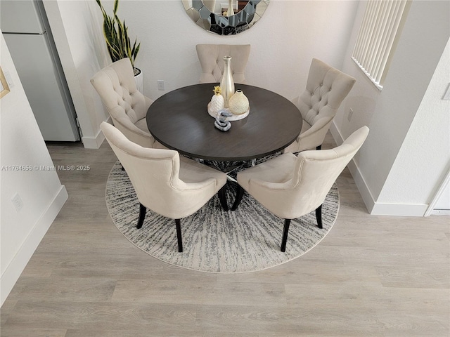 dining room featuring baseboards and wood finished floors