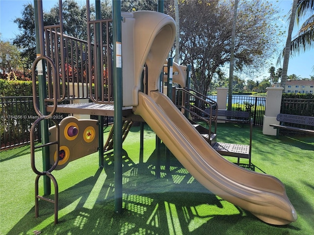 community playground featuring a lawn and fence