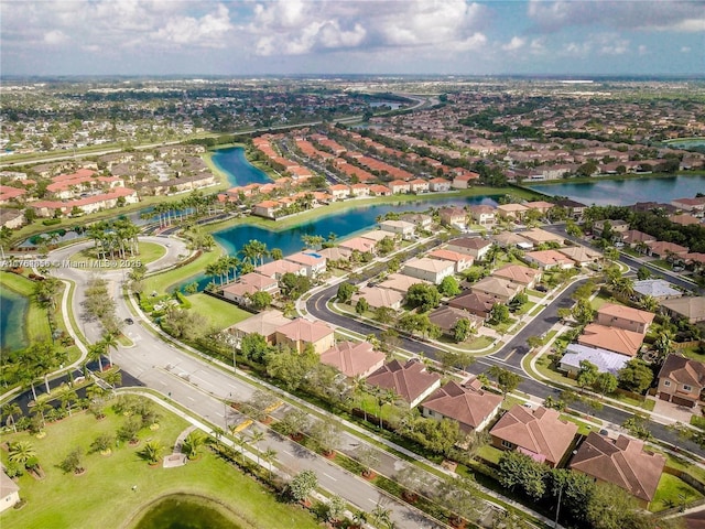 drone / aerial view featuring a residential view and a water view