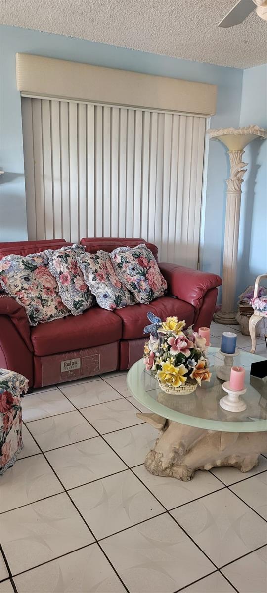 4801 NW 7th St Unit 810-16, Miami, FL 33126 - living area with a textured ceiling, a ceiling fan, and tile patterned flooring