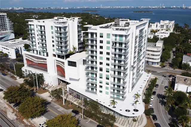 birds eye view of property featuring a city view and a water view