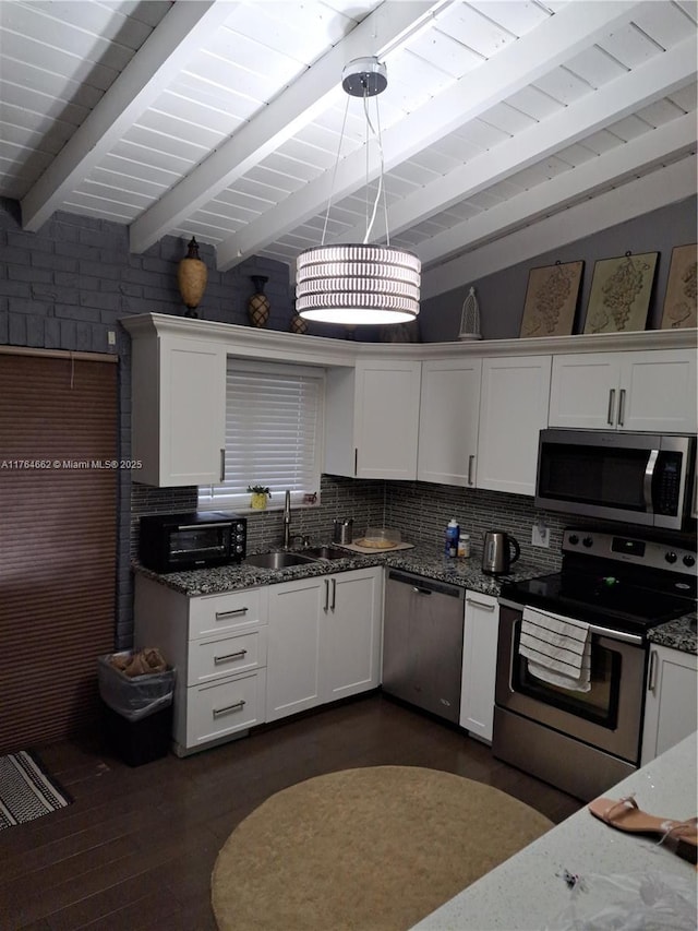 911 W Country Club Cir, Plantation, FL 33317 - kitchen with a sink, dark stone countertops, stainless steel appliances, white cabinets, and decorative backsplash