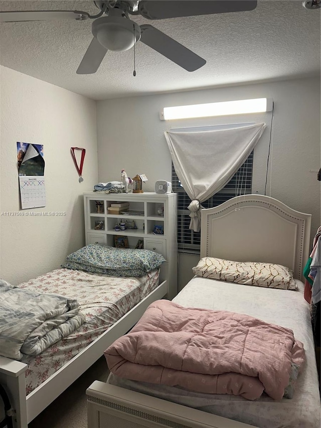 bedroom featuring a textured ceiling and ceiling fan