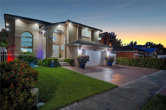 13021 NW 11th Ter, Miami, FL 33182 - view of front of home with a tiled roof, decorative driveway, a lawn, and stucco siding