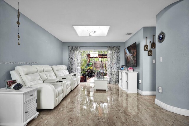 13021 NW 11th Ter, Miami, FL 33182 - living area with visible vents, baseboards, marble finish floor, and a skylight