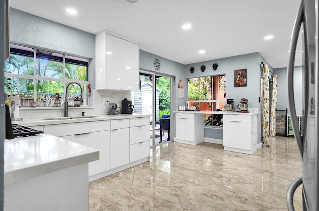 13021 NW 11th Ter, Miami, FL 33182 - kitchen featuring modern cabinets, marble finish floor, a sink, white cabinets, and light countertops