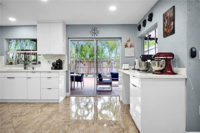 13021 NW 11th Ter, Miami, FL 33182 - kitchen featuring white cabinetry, light countertops, modern cabinets, and a textured wall