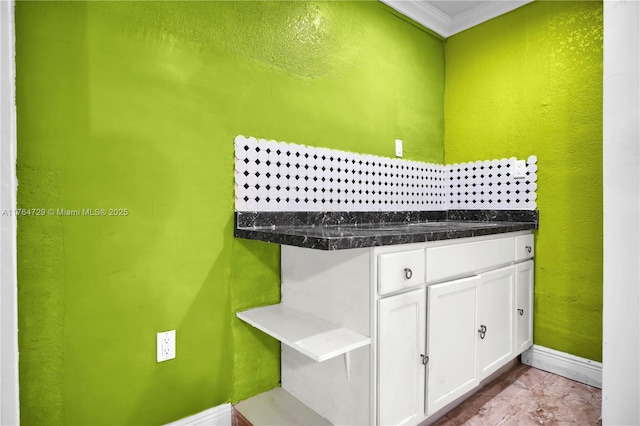 13021 NW 11th Ter, Miami, FL 33182 - kitchen with a textured wall, white cabinets, baseboards, and ornamental molding