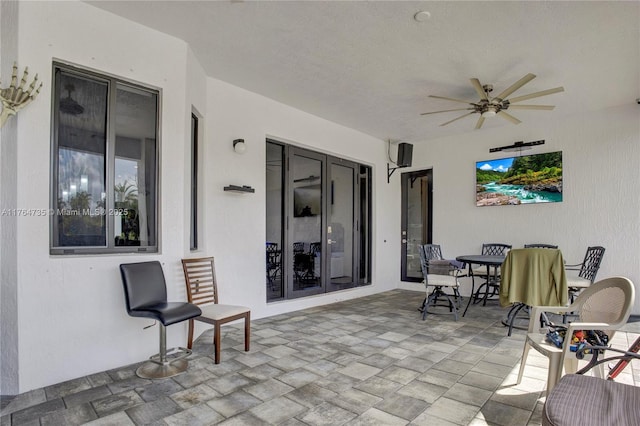 view of patio featuring outdoor dining area and ceiling fan