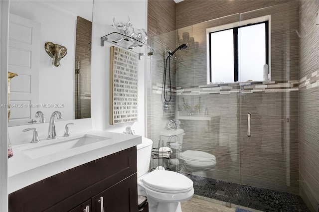 full bath with vanity, toilet, and a shower stall