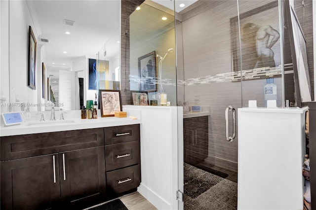 full bathroom with visible vents, recessed lighting, tile walls, a shower stall, and vanity