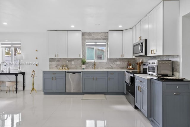 10341 SW 150th Ter, Miami, FL 33176 - kitchen with a sink, backsplash, appliances with stainless steel finishes, and white cabinets