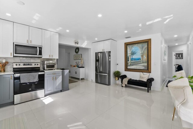 10341 SW 150th Ter, Miami, FL 33176 - kitchen featuring tasteful backsplash, appliances with stainless steel finishes, white cabinetry, and light countertops