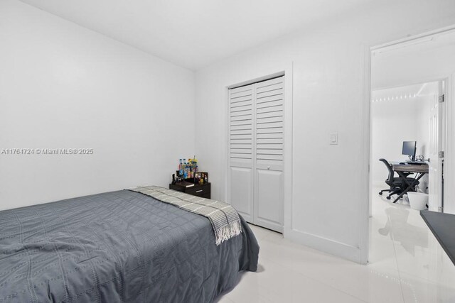 10341 SW 150th Ter, Miami, FL 33176 - bedroom with light tile patterned floors and a closet