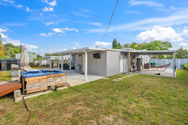 10341 SW 150th Ter, Miami, FL 33176 - rear view of property featuring a patio, a lawn, and a fenced backyard