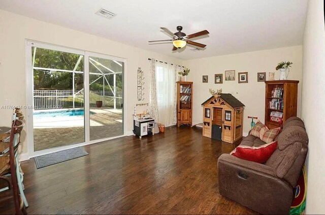 1020 NW Leonardo Cir, Port St Lucie, FL 34986 - living area with visible vents, a healthy amount of sunlight, ceiling fan, and wood finished floors