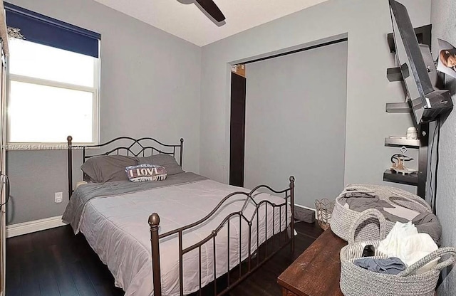 1020 NW Leonardo Cir, Port St Lucie, FL 34986 - bedroom featuring baseboards, wood finished floors, and a ceiling fan