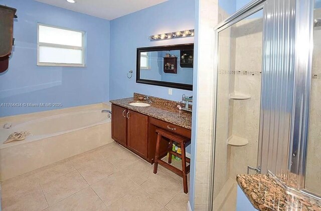 1020 NW Leonardo Cir, Port St Lucie, FL 34986 - full bath featuring a bath, tile patterned floors, vanity, and a stall shower