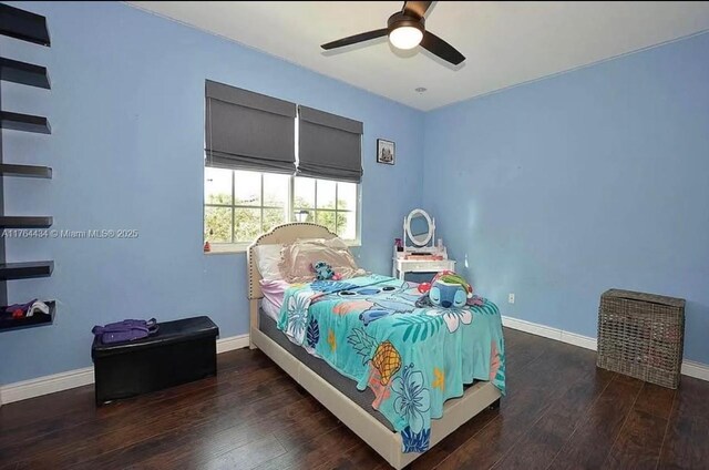 1020 NW Leonardo Cir, Port St Lucie, FL 34986 - bedroom featuring ceiling fan, baseboards, and wood finished floors