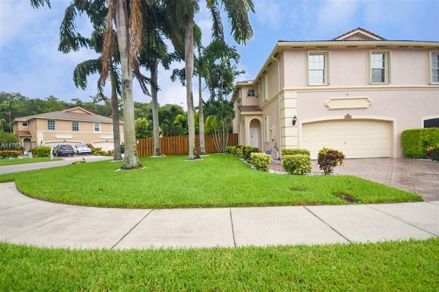 view of front of property featuring fence, driveway, an attached garage, stucco siding, and a front lawn
