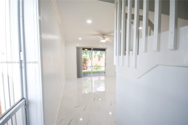 corridor featuring recessed lighting, marble finish floor, and ornamental molding