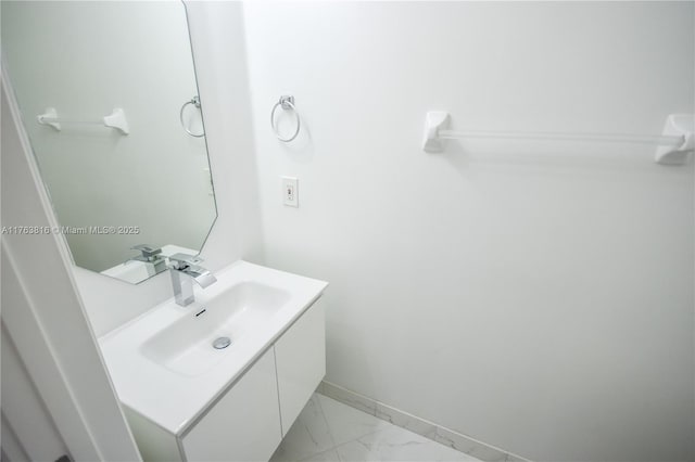bathroom with vanity, baseboards, and marble finish floor