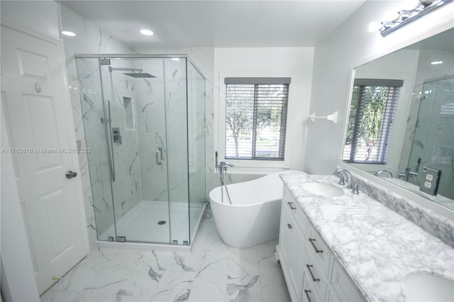 full bathroom featuring double vanity, marble finish floor, a marble finish shower, and a sink