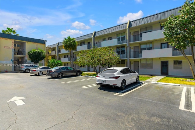 view of property featuring uncovered parking and a residential view