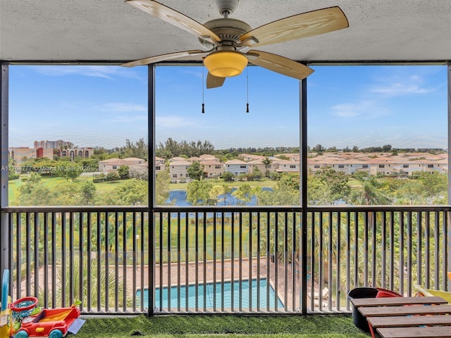 900 NE 195th St Unit 504, Miami, FL 33179 - unfurnished sunroom featuring a ceiling fan and a residential view