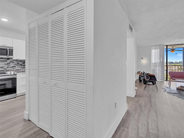 900 NE 195th St Unit 504, Miami, FL 33179 - corridor featuring visible vents, baseboards, recessed lighting, floor to ceiling windows, and light wood-type flooring