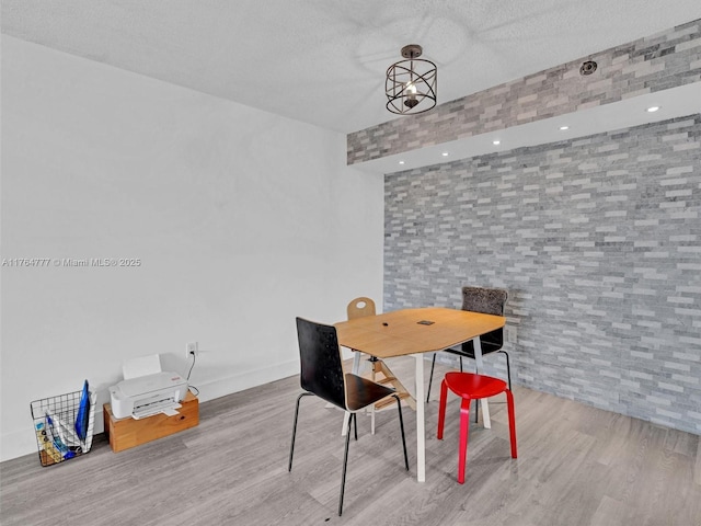 900 NE 195th St Unit 504, Miami, FL 33179 - dining area featuring baseboards, a textured ceiling, and wood finished floors