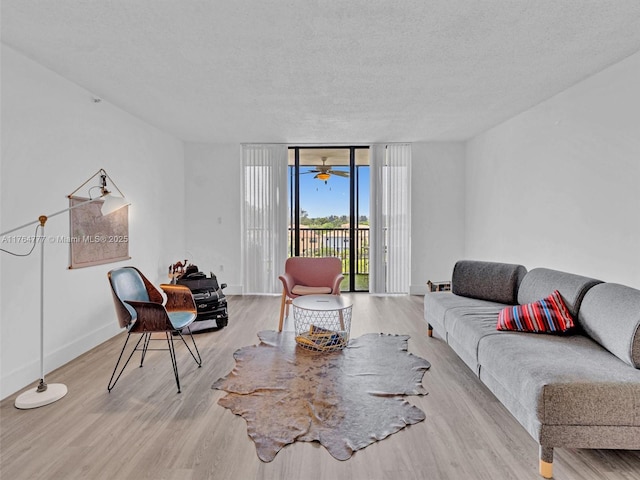 900 NE 195th St Unit 504, Miami, FL 33179 - living area with baseboards, a textured ceiling, wood finished floors, and floor to ceiling windows