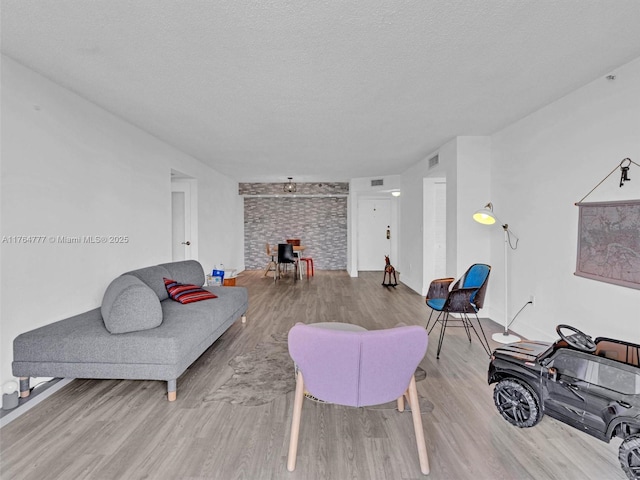 900 NE 195th St Unit 504, Miami, FL 33179 - living area featuring visible vents, a textured ceiling, and wood finished floors