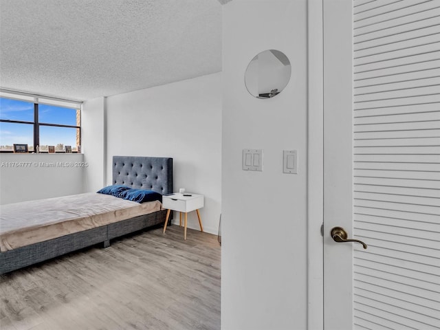 900 NE 195th St Unit 504, Miami, FL 33179 - bedroom with wood finished floors and a textured ceiling