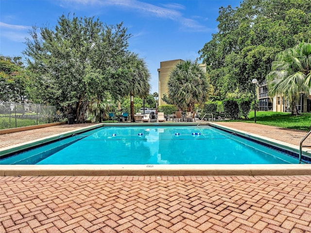900 NE 195th St Unit 504, Miami, FL 33179 - pool featuring a patio area and fence