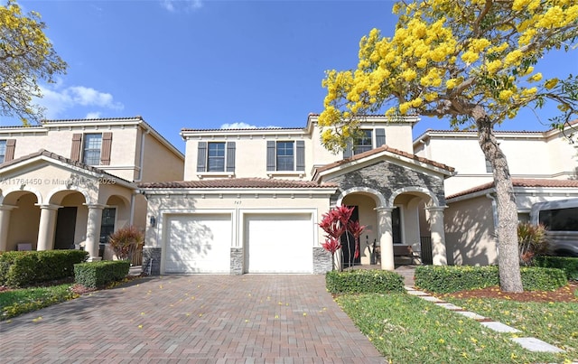747 NE 193rd Ter, Miami, FL 33179 - view of front of property with decorative driveway, stone siding, a tile roof, and stucco siding