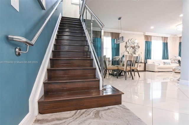 747 NE 193rd Ter, Miami, FL 33179 - staircase featuring tile patterned flooring, a healthy amount of sunlight, baseboards, and ornamental molding