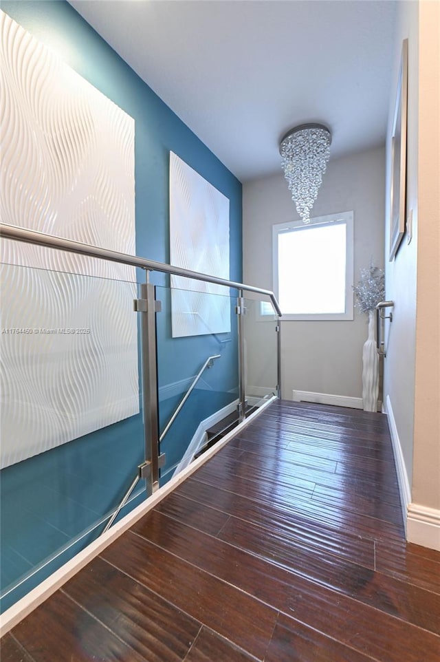747 NE 193rd Ter, Miami, FL 33179 - interior space with baseboards, an inviting chandelier, and hardwood / wood-style floors