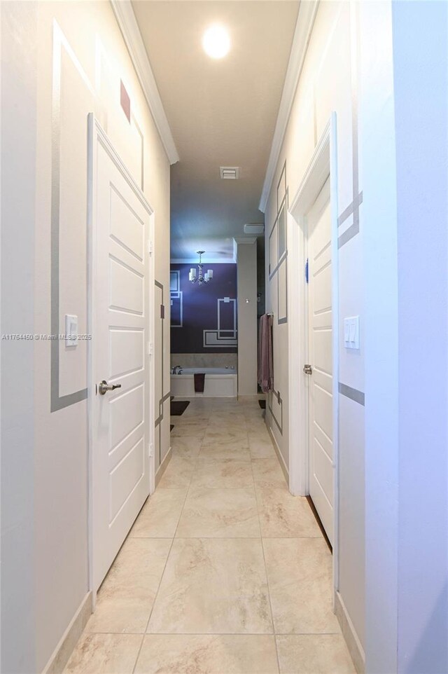 747 NE 193rd Ter, Miami, FL 33179 - corridor with light tile patterned floors, visible vents, baseboards, and crown molding