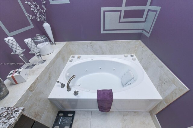 747 NE 193rd Ter, Miami, FL 33179 - bathroom with tile patterned flooring and a tub with jets