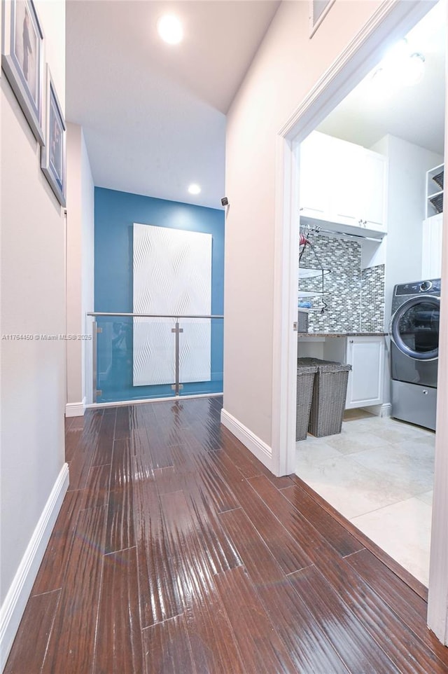 747 NE 193rd Ter, Miami, FL 33179 - corridor featuring baseboards, washer / clothes dryer, and wood finished floors