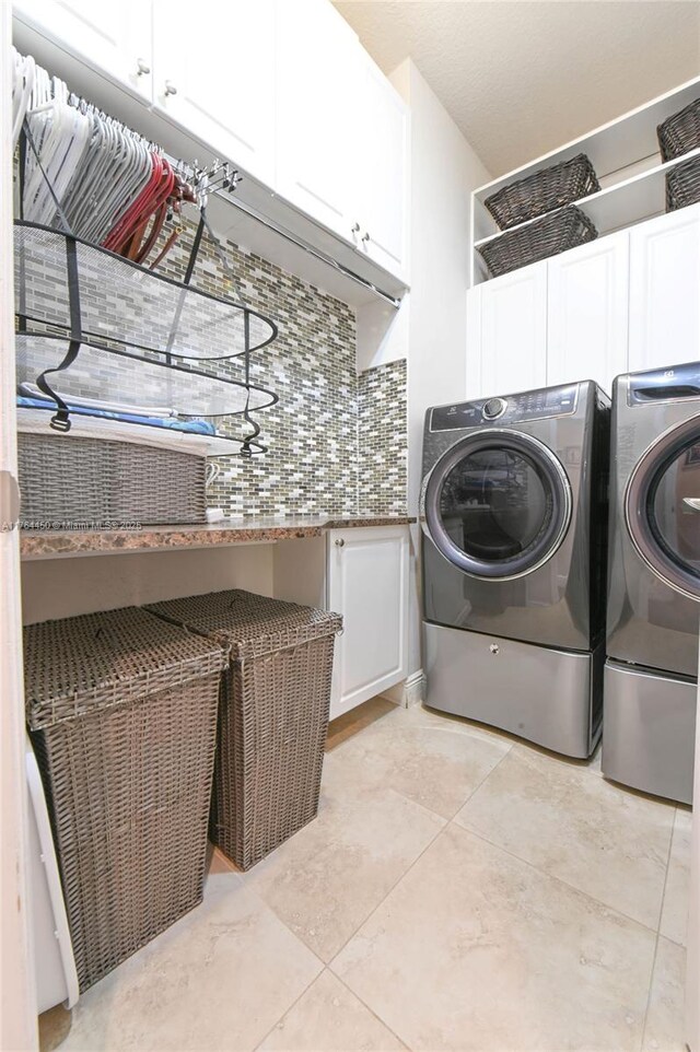 747 NE 193rd Ter, Miami, FL 33179 - washroom featuring light tile patterned floors, cabinet space, and separate washer and dryer