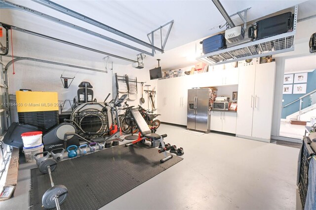 747 NE 193rd Ter, Miami, FL 33179 - workout room featuring a garage